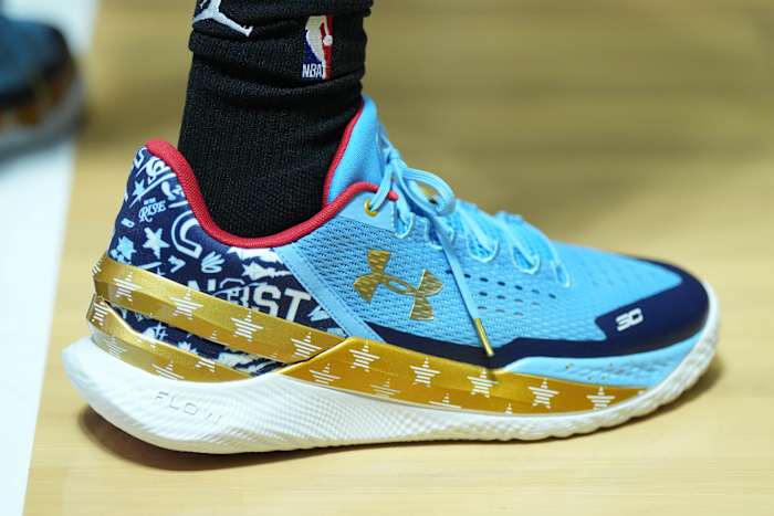 View of De'Aaron Fox's blue and gold shoes.